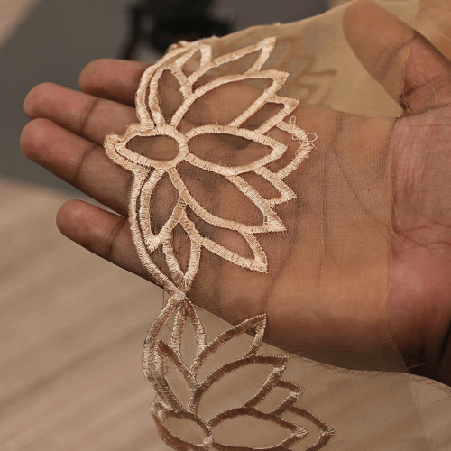 Elegant embroidered laces crafted by Mehran Enterprise, featuring intricate threadwork for bridal fashion, formalwear, and luxury textile designs.