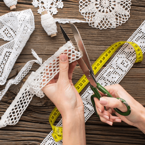 Artisan handcrafting lace with fine detailing for high-quality garments and textiles.