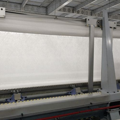 Schiffli Saurer embroidery machine used by Mehran Enterprise for producing detailed lace and fabric embroidery in large-scale textile manufacturing.