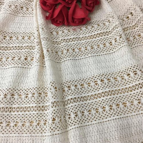 Crochet knitted lace fabrics with intricate designs, crafted by Mehran Enterprise for use in bridal wear, fashion garments, and home textiles.